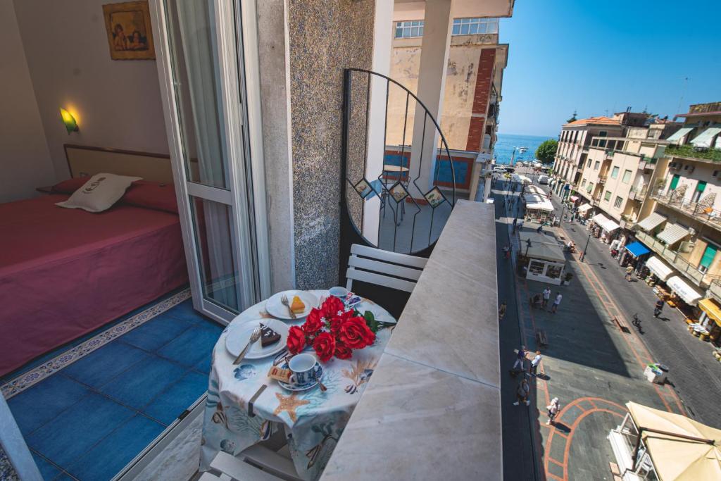 a balcony with a table and a view of a city at Meublè Casa Mannini Rooms in Maiori