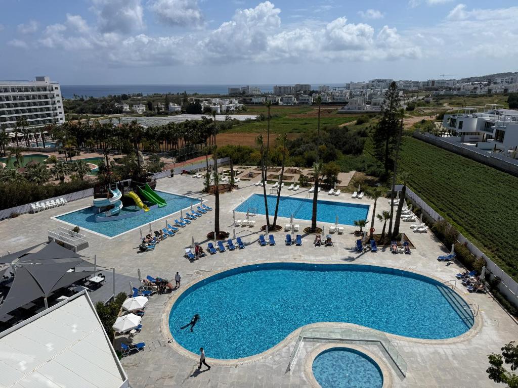an overhead view of a large swimming pool at Papouis Protaras Hotel in Protaras