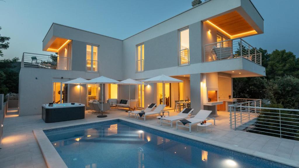 a house with a swimming pool in front of it at VILLA MON AMOUR by Villas Guide in Blato