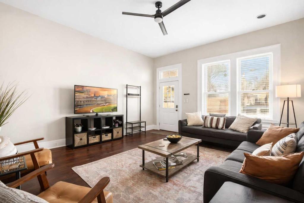 a living room with a couch and a table at Derby & Bourbon Trail Homebase W Private Backyard in Louisville