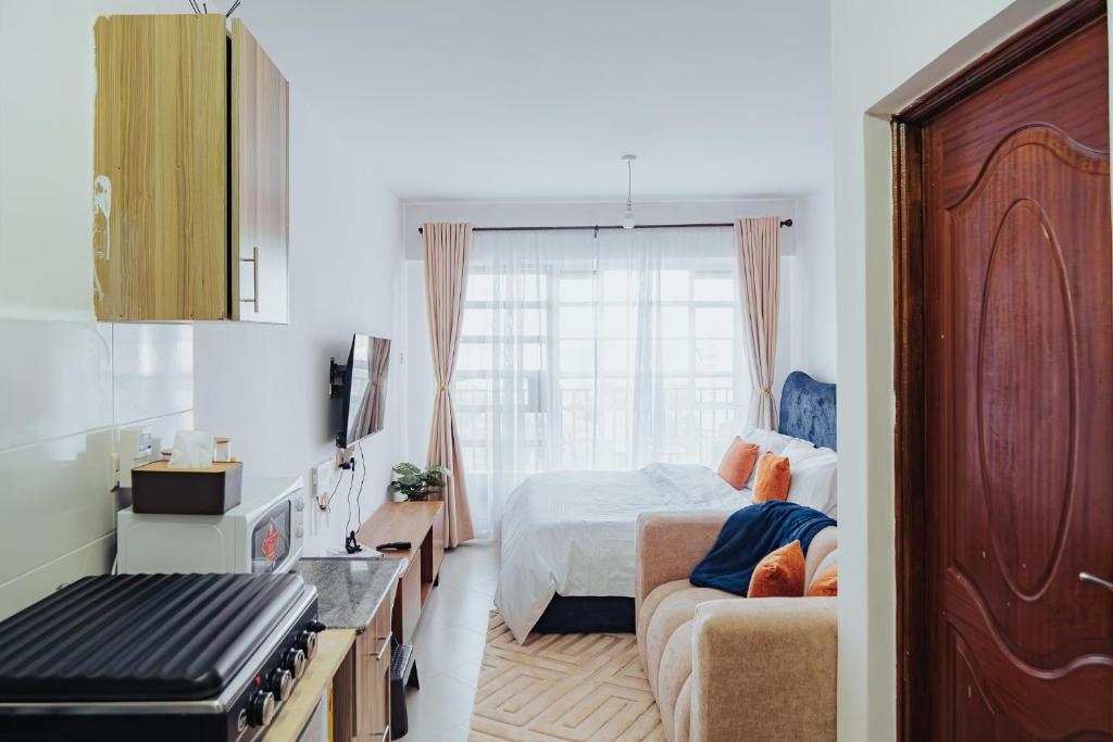 a bedroom with a bed and a couch at Work Friendly Studio near Nairobi CBD and Westlands in Nairobi