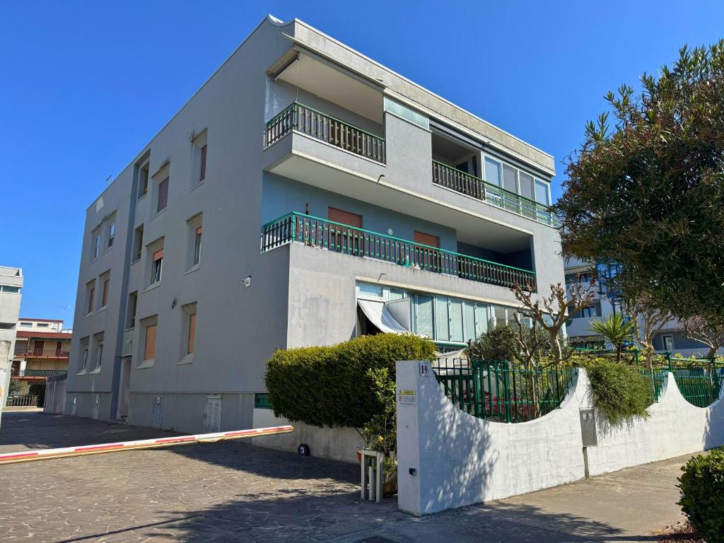 a white building with balconies on the side of it at Villa Terme in Grado