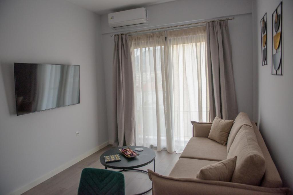 a living room with a couch and a large window at The ViewPoint VP3 in Mytilene