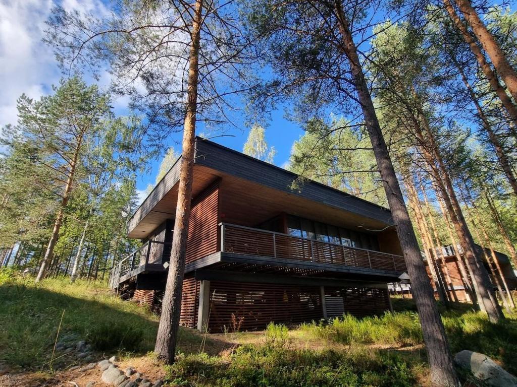 a log cabin in the woods with trees at Tikankolo in Puumala