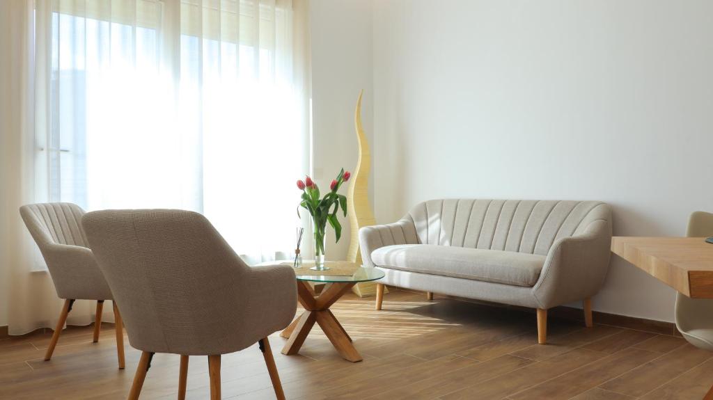 a living room with a couch and a chair and a table at L'Eden di Nicolas in San Costantino Calabro