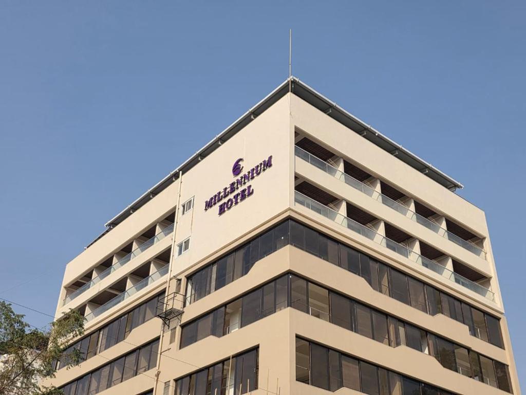 a building with a sign on the top of it at Millennium Hotel in Nashik