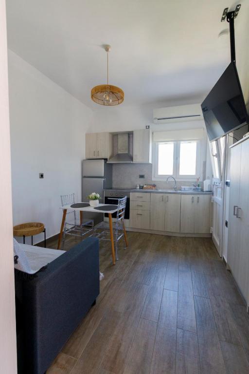 a kitchen with a table and a dining room at La casa nel campo in Syros Island National Airport