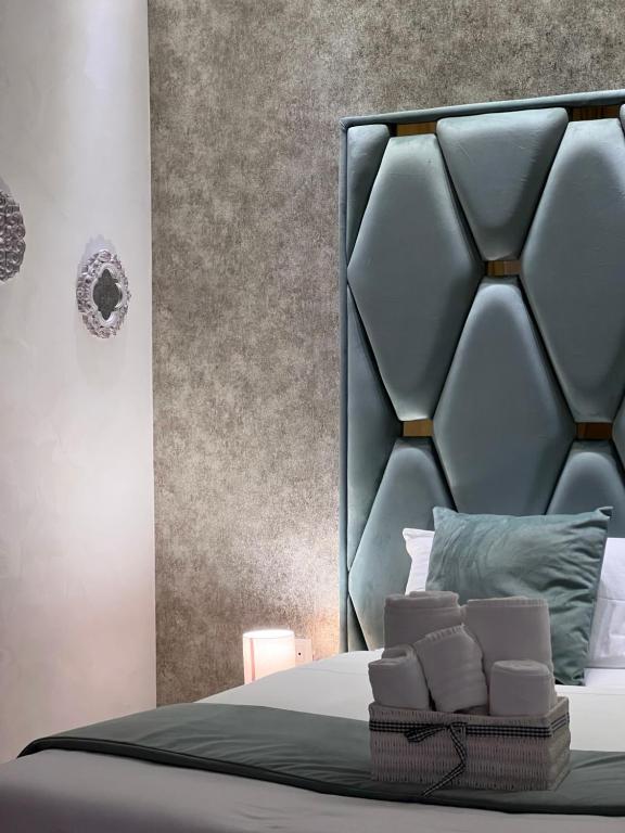 a bedroom with a bed with a black headboard at Stay & Fly in Naples