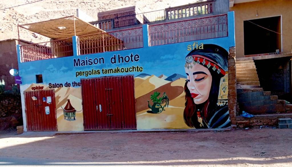 a mural of a woman on the side of a building at Pergolas Tamakoucht in Ouarzazate
