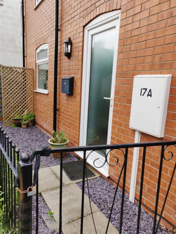 a door to a brick house with the number at Naam Place in Lincoln