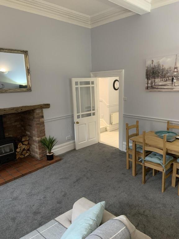 a living room with a couch and a table at Hursley Lodge in Lincoln