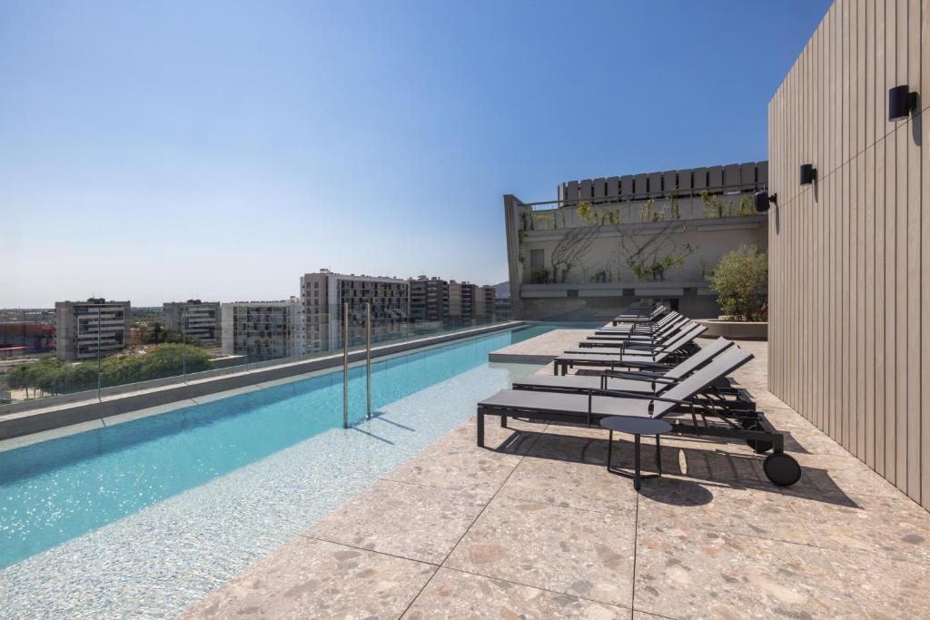 a swimming pool on the roof of a building at Hotel SB Win 4 Sup in Sant Feliu de Llobregat
