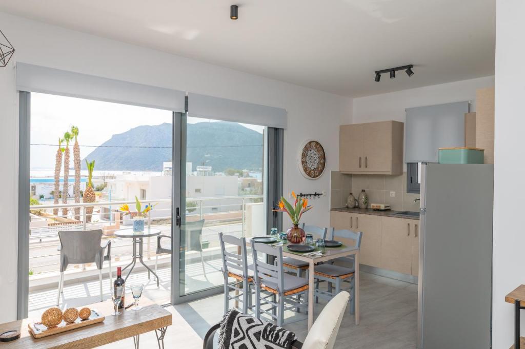 a kitchen and dining room with a view of the ocean at Ocean Breeze Residence in Kámpos