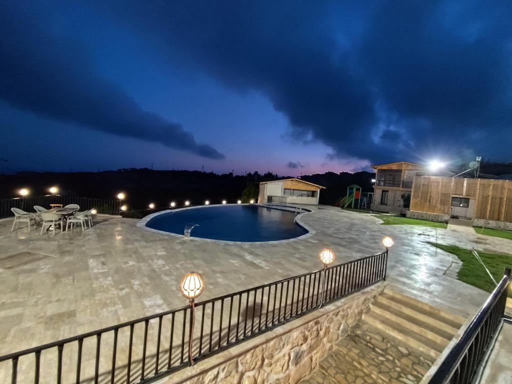 a view of a swimming pool at night at Luna Home Club in Samandağı
