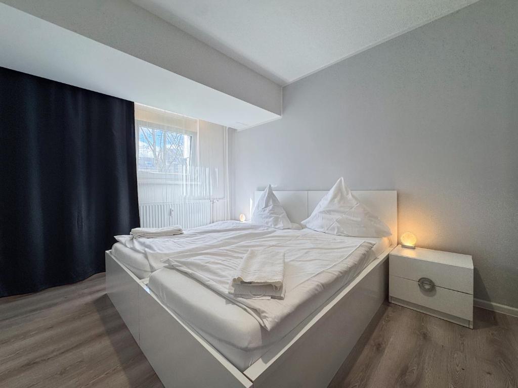 a white bed in a room with a window at City-Apartment Spreeufer im Herzen Berlins in Berlin