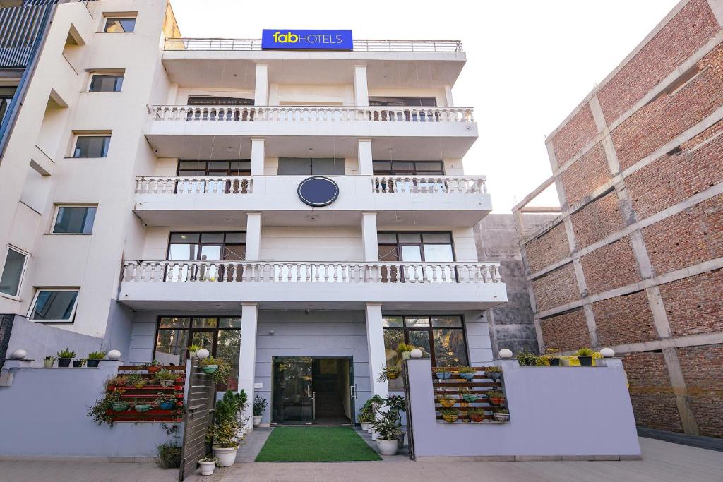 an apartment building with a sign on it at FabHotel Sager Inn in Gurgaon
