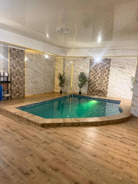 a swimming pool in a large room with a large at INFINITY Hotel&Spa in Almaty