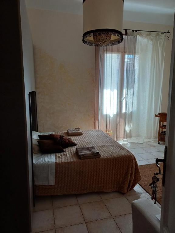 a bedroom with a bed and a large window at Marina's House in La Spezia