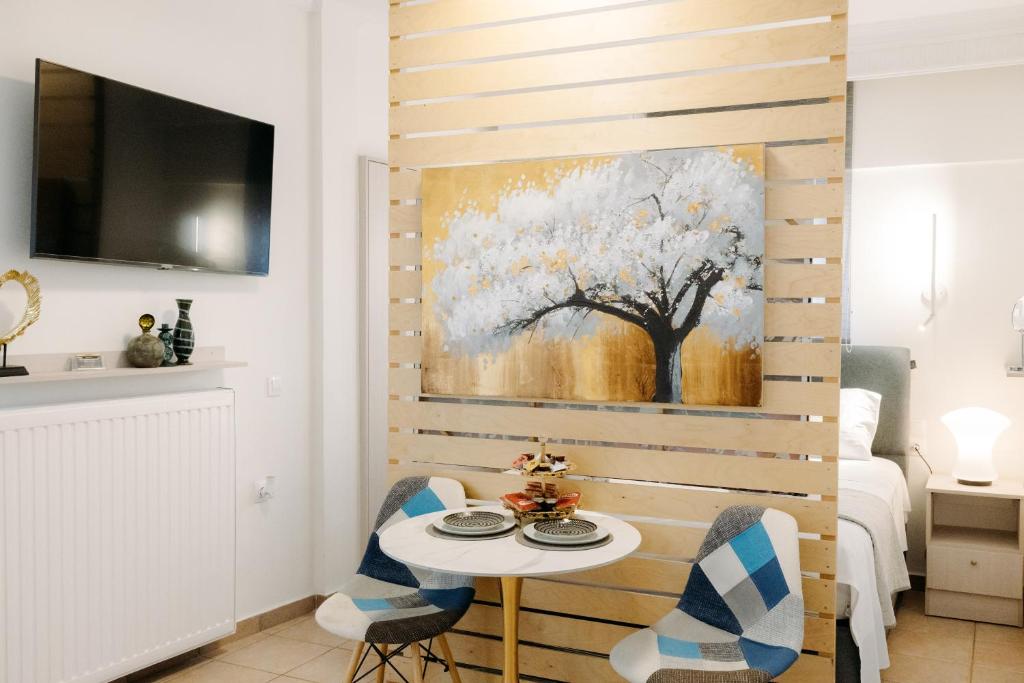 a room with a table and a painting on the wall at Nuance Residences - Cresento in Volos