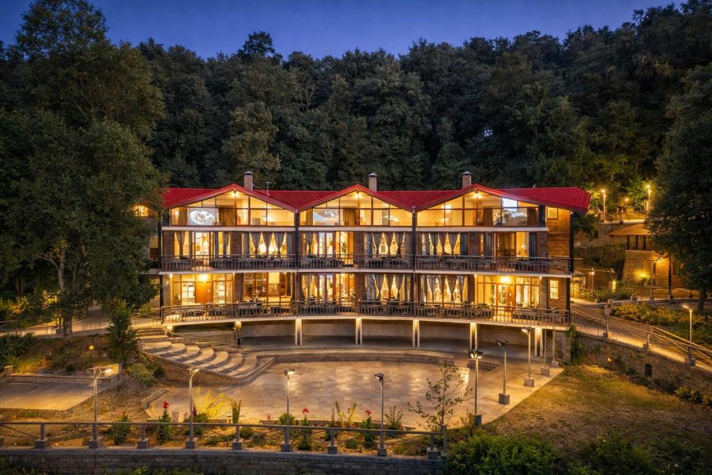 a large building with a red roof at night at THE CEDAR CASTLE in Mukteshwar
