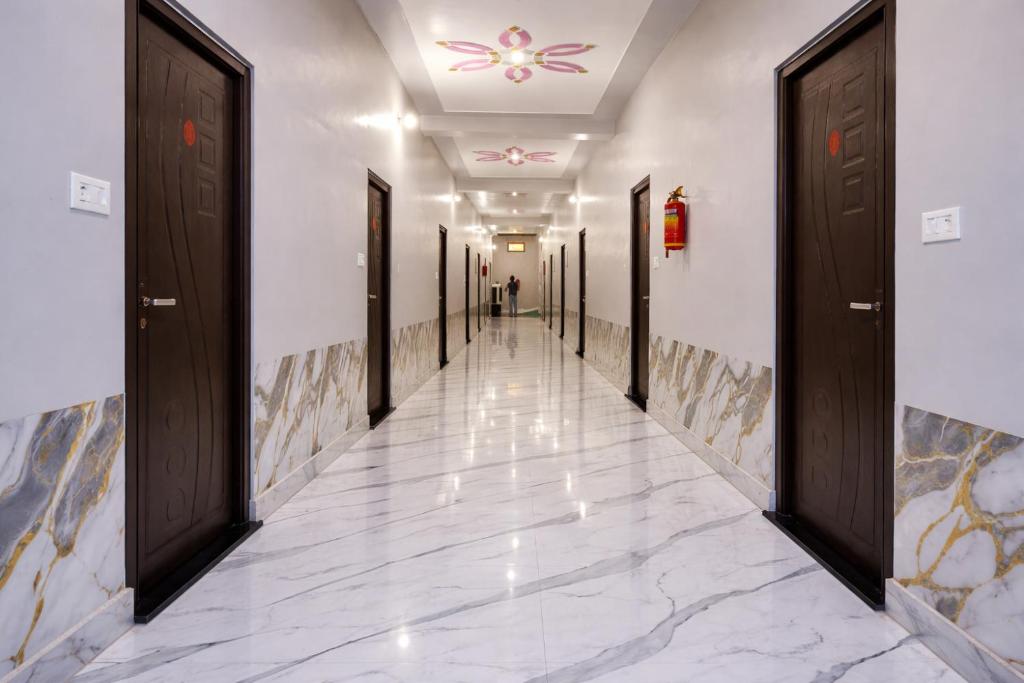 a hallway with doors and a tile floor at Ayodhya Stay in Ayodhya