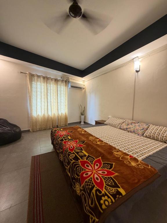 a bedroom with a large bed with a colorful blanket at Bliss Stay in Mūvattupula