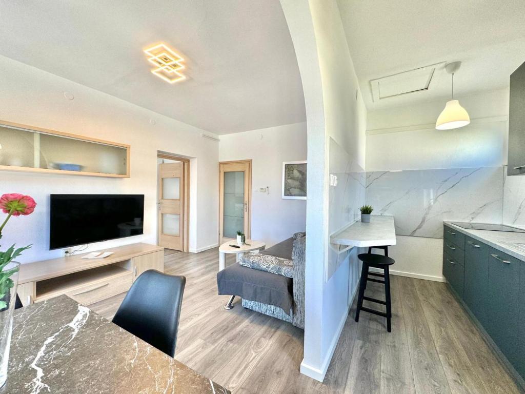 a kitchen and living room with a television and a couch at Adrijana 2 in Krk