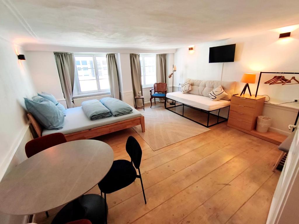 a living room with a bed and a couch at Globetrotter Apartments in Konstanz