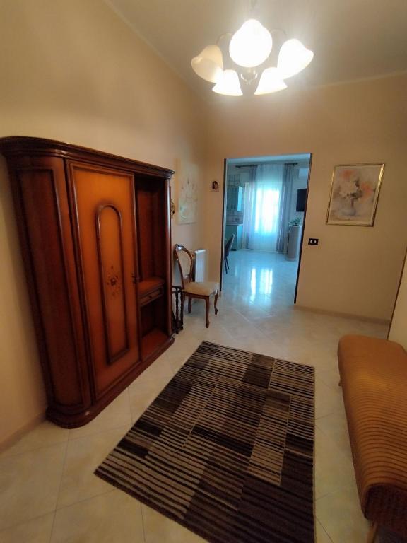 a living room with a brown cabinet and a rug at Karina in Carini