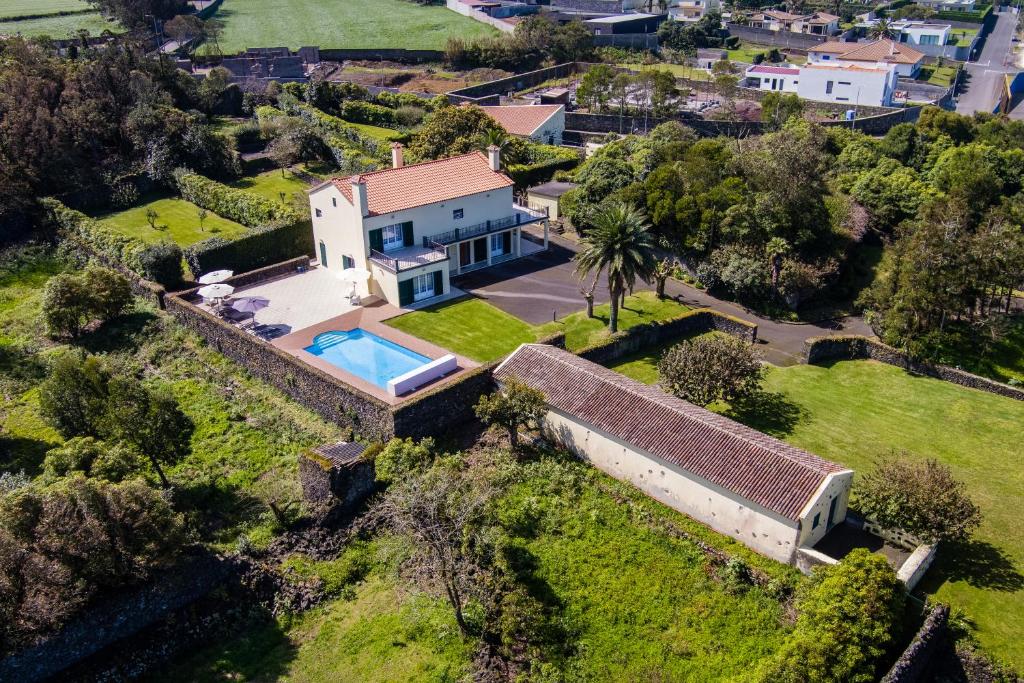 an aerial view of a house with a swimming pool at Quinta da Lu - Azorean Villa in Ribeira Grande