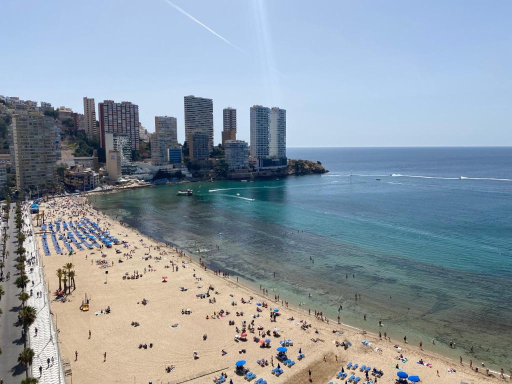 a group of people on a beach near the ocean at Veracruz-Fincas Benidorm in Benidorm