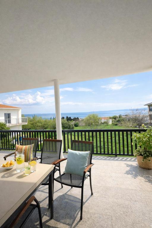 a patio with a table and chairs on a balcony at GUESTHOUSE Kastel Novi 2 More Space in Kaštela