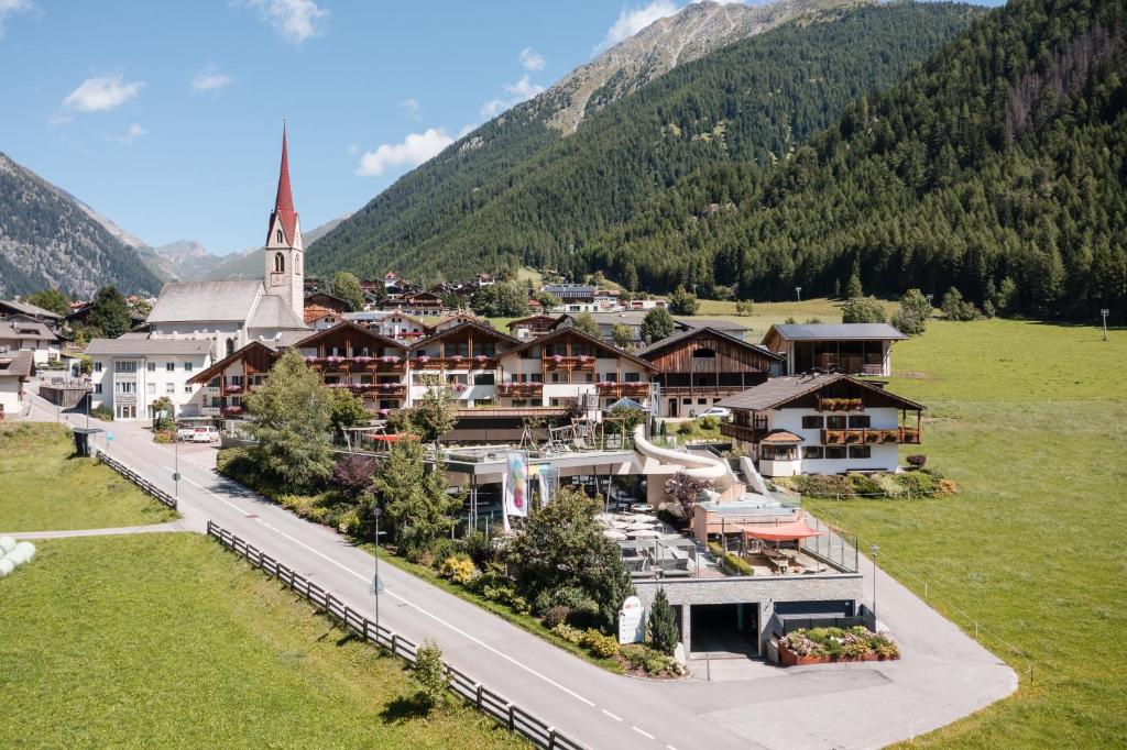 an aerial view of a village with a church at Familienhotel Huber in Valles
