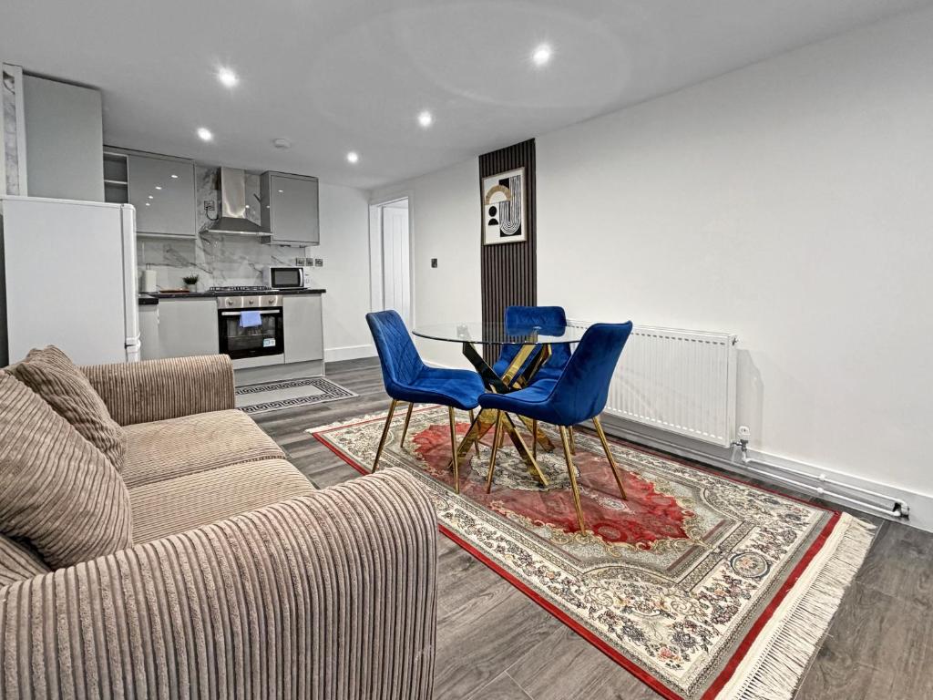 a living room with a couch and a table and chairs at Bletchley Retreat in Bletchley