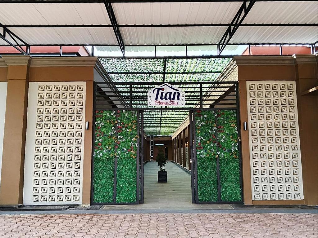 an entrance to a building with a sign on it at Hotel Tian in Nabire