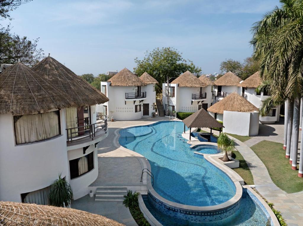 an image of a resort with a swimming pool at Treat Resort Rajkot in Rajkot
