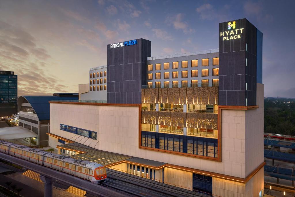 a rendering of a hotel with a train in front of it at Hyatt Place Bhopal in Bhopal