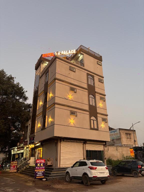 a tall building with a car parked in front of it at Hotel KK Place in Chittaurgarh