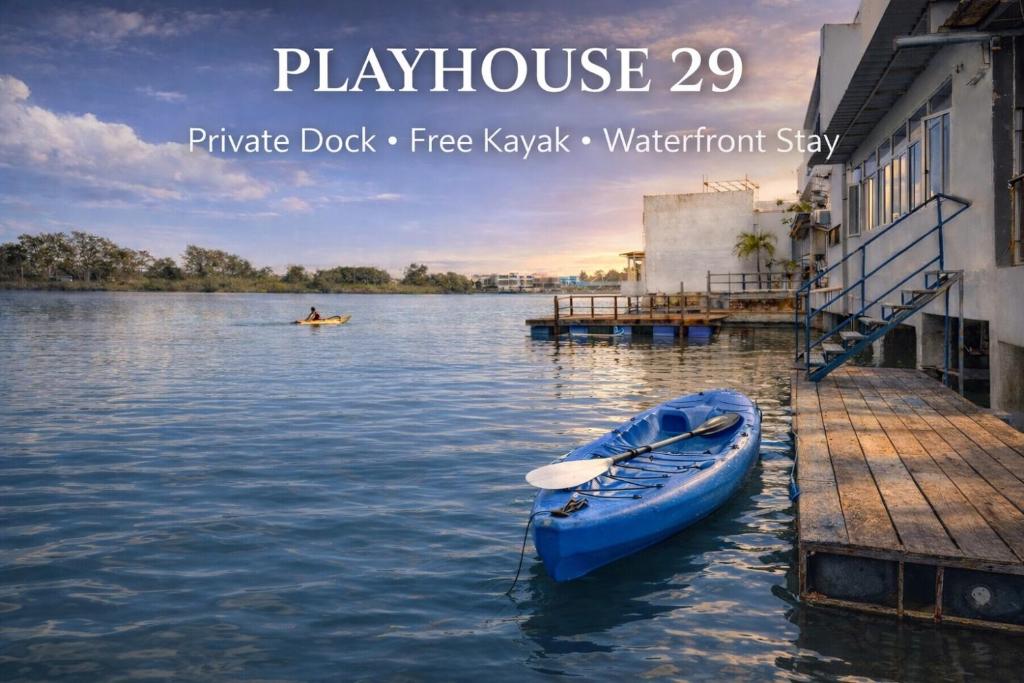 a blue kayak sitting on the water next to a dock at Entire Villa, Ferry Terminal Pickup & Breakfast in Batam Center
