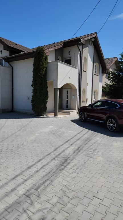 a car parked in front of a house at ILSA Properties in Craiova