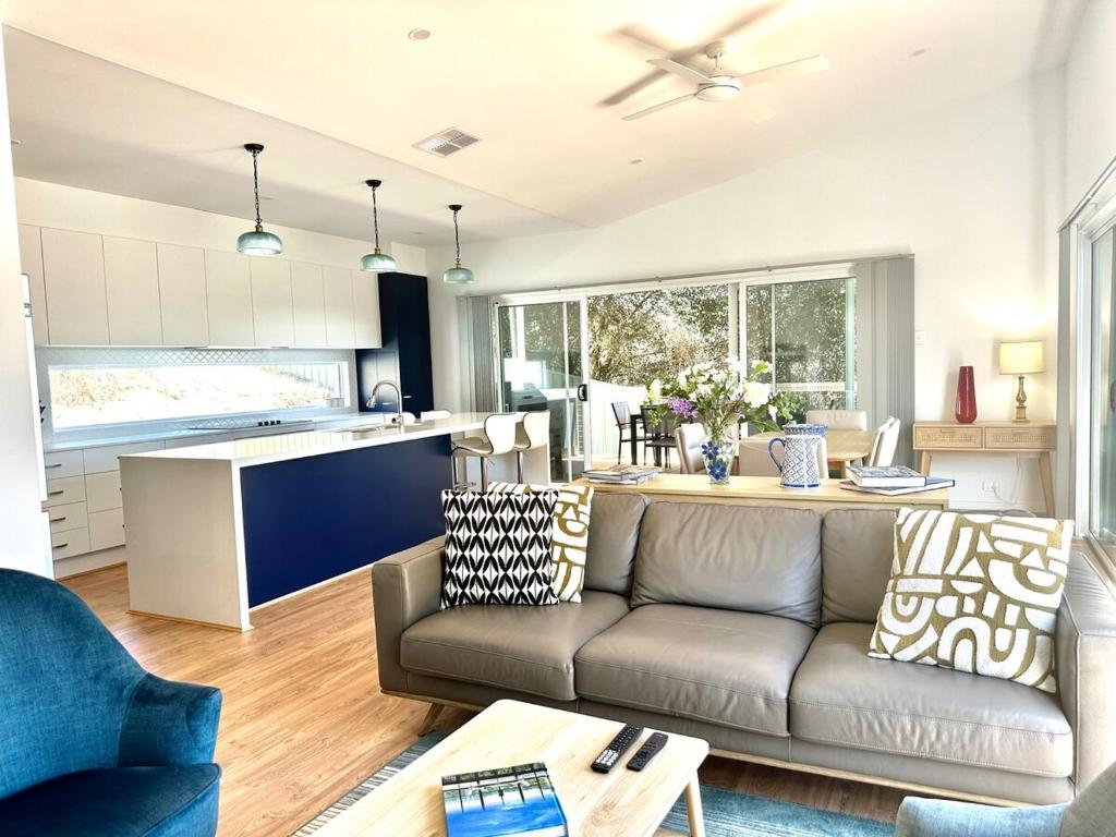 a living room with a couch and a kitchen at The Blue Nest, Clare in Clare