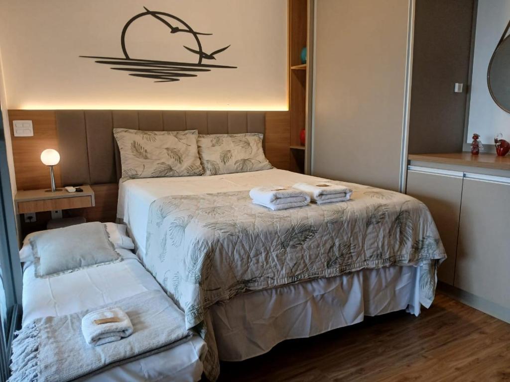 a bedroom with a bed with towels on it at Giardino Pretty Studio - GRU 1405 in Guarulhos