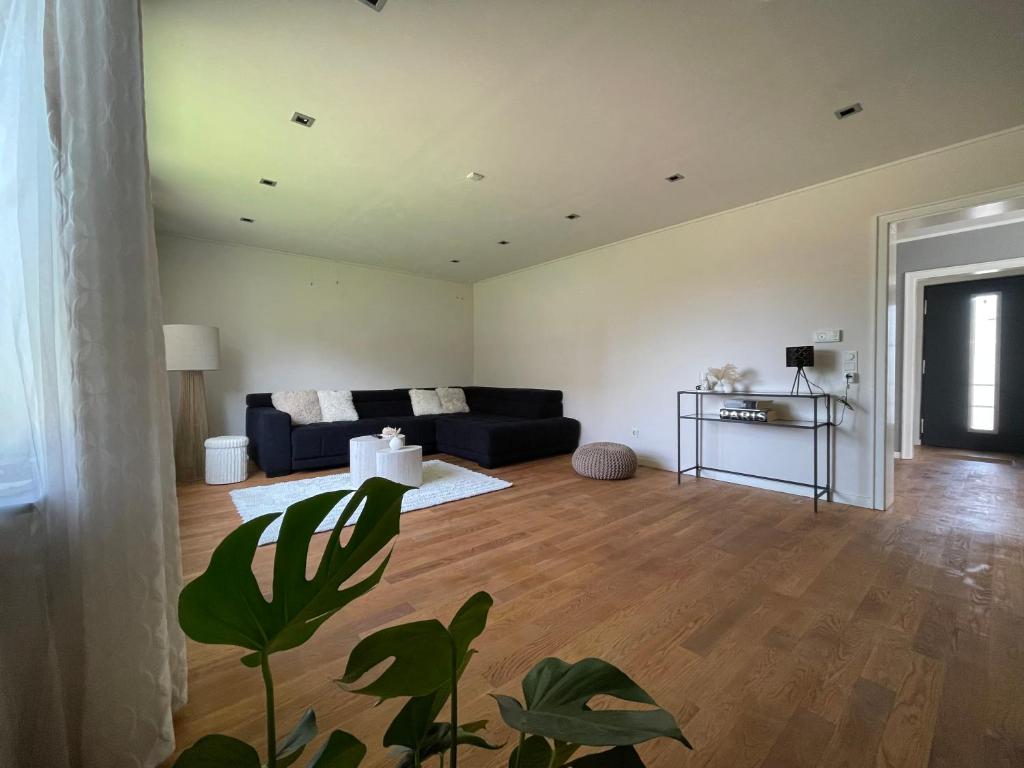 a living room with a couch and a table at Ferienhaus Heimatgefühl in Würselen