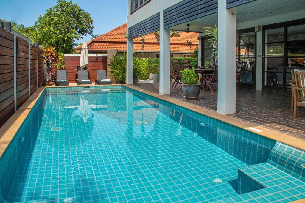 a swimming pool in a house with at Malee Beach C8 in Phra Ae beach