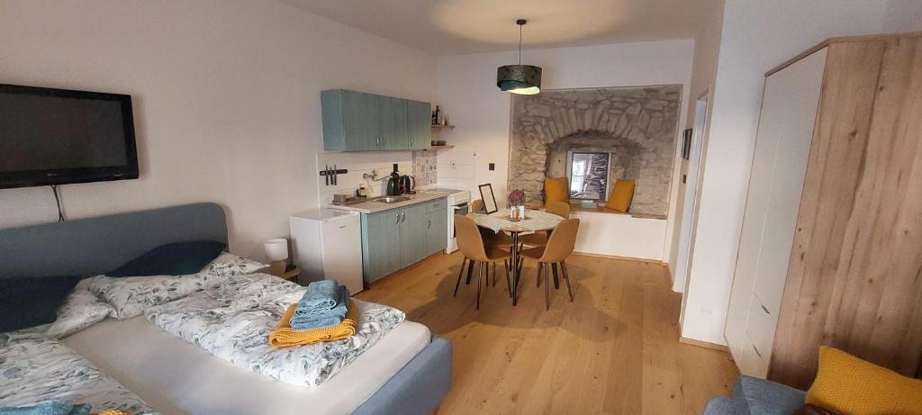 a living room with a couch and a kitchen at Vocell in Kutná Hora
