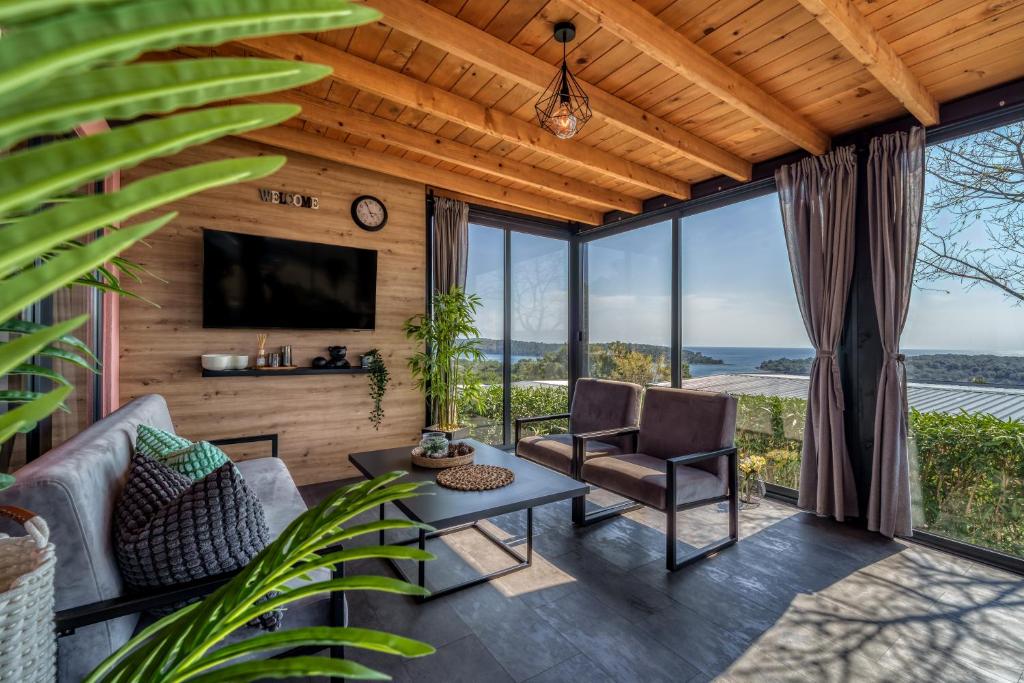 a living room with a couch and a table at Sea view SanNor by Vellaris, Luxury Mobile Home in Mali Lošinj