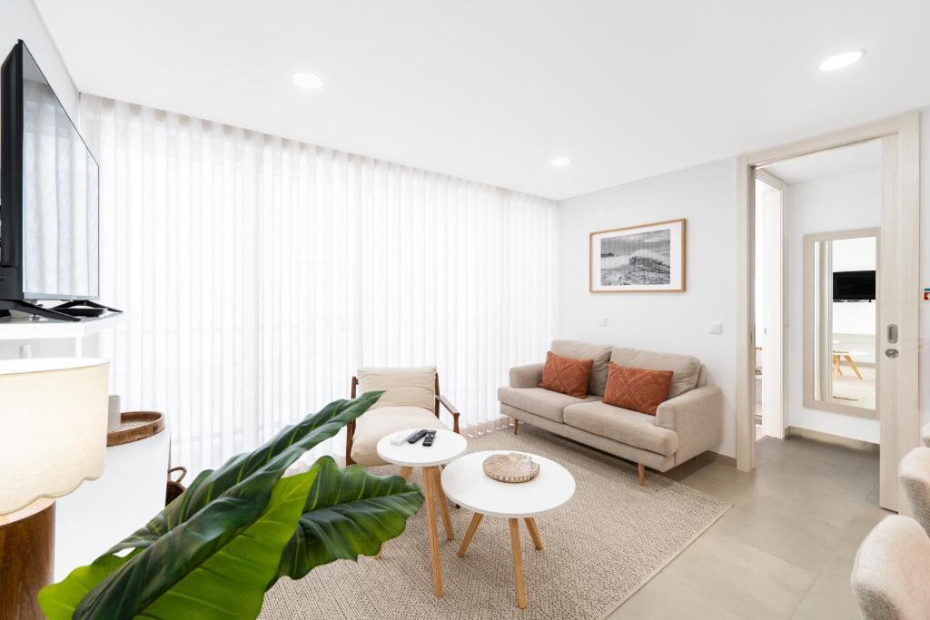 a living room with a couch and a table at Big Waves Retreat Nazaré - By Nest & Co in Nazaré