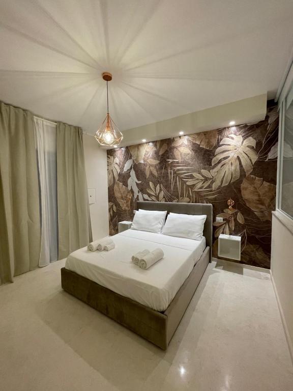 a bedroom with a large bed with a painting on the wall at Suite 55 in Trani