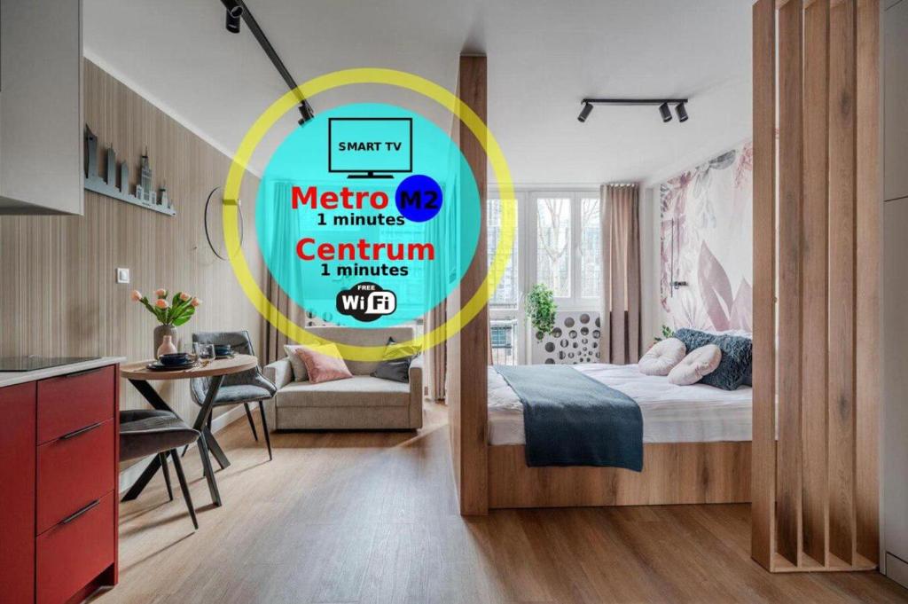 a bedroom with a bed and a table and a kitchen at Pereca City Centre Studios by Arrenda in Warsaw