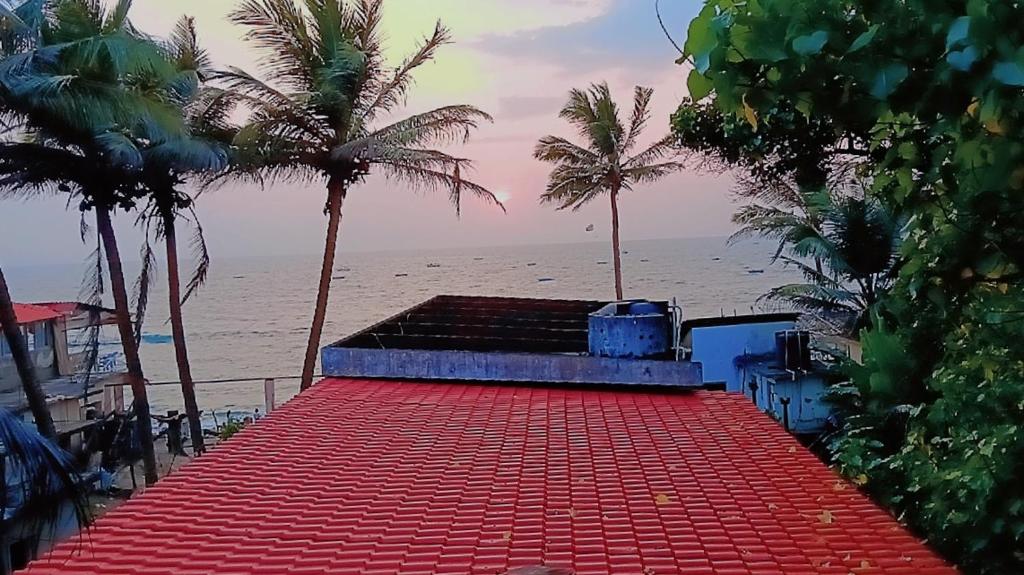 a red carpet on the beach with palm trees at NEW BEACH HOTEL Anjuna in Anjuna